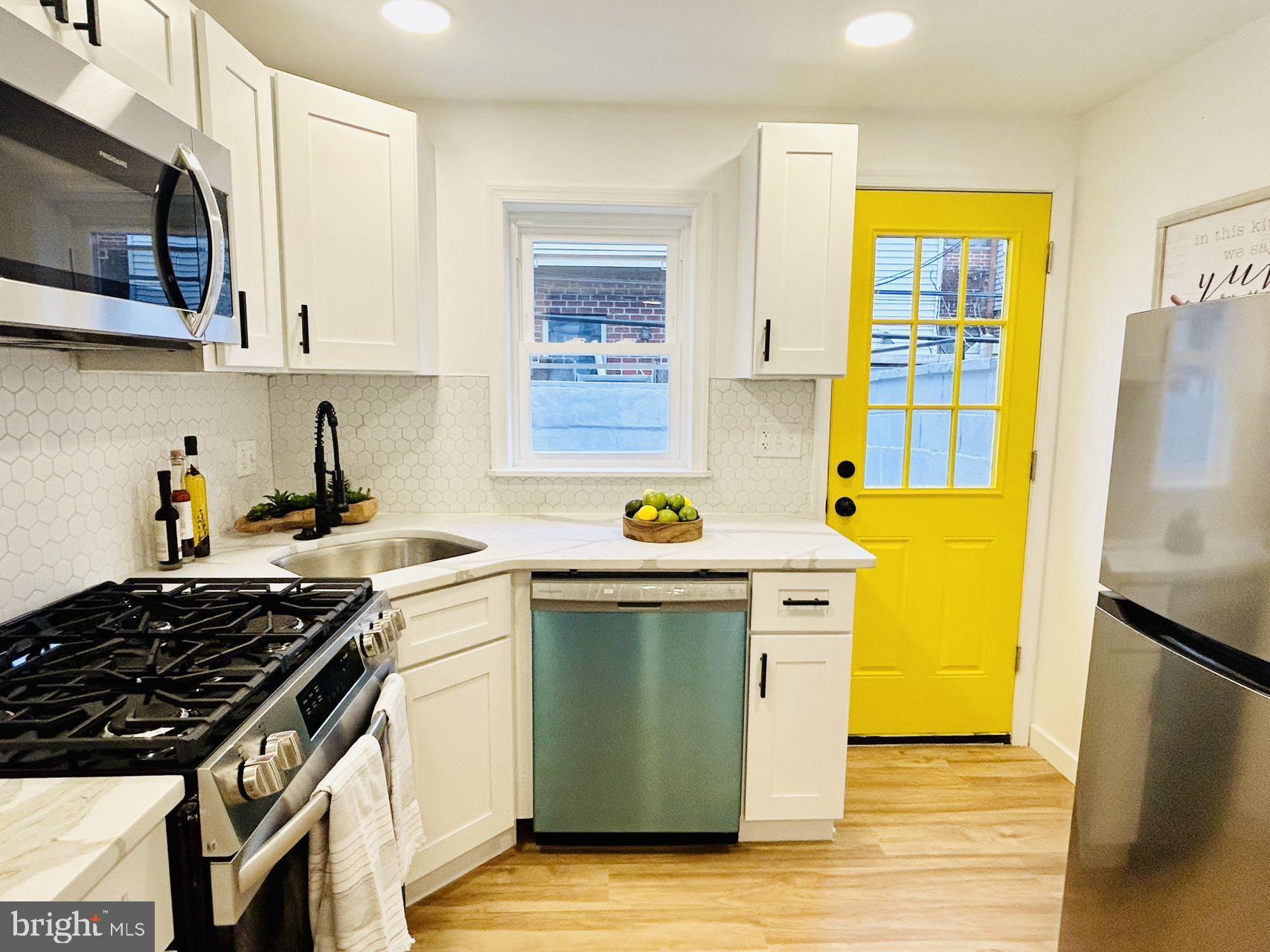 2013 South Bouvier Street Philadelphia, PA 19145 - Photo 5 of 18 a kitchen with stainless steel appliances a stove sink and refrigerator