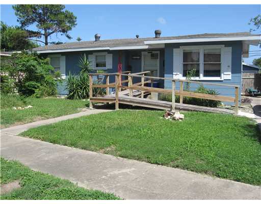 a view of a house with a yard and sitting area