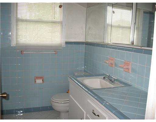 1345 Ray Drive Corpus Christi, TX 78411 - Photo 3 of 7 a bathroom with a sink a toilet and a window