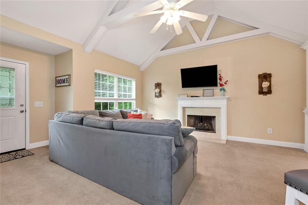 1044 Lothridge Road Cleveland, GA 30528 - Photo 10 of 40 a living room with furniture a flat screen tv and a fireplace