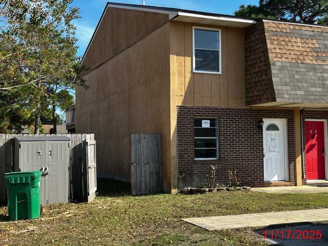145 4th Avenue, Unit E4 Shalimar, FL 32579 - Photo 17 of 24 a view of a house with a backyard