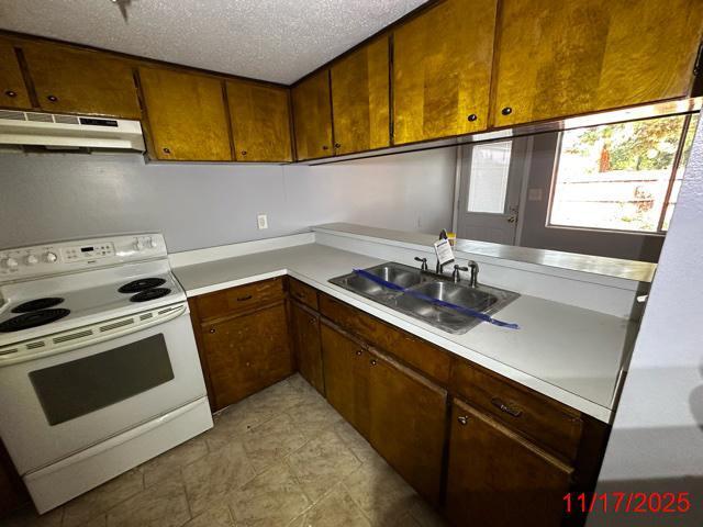 145 4th Avenue, Unit E4 Shalimar, FL 32579 - Photo 18 of 24 a kitchen that has a sink and a stove