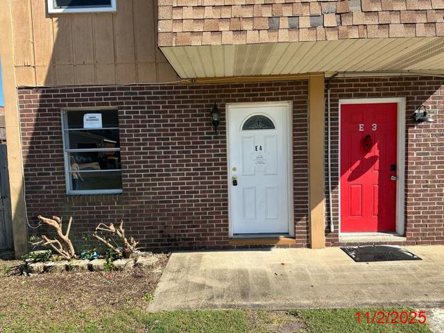 145 4th Avenue, Unit E4 Shalimar, FL 32579 - Photo 2 of 24 a front view of a house with parking area