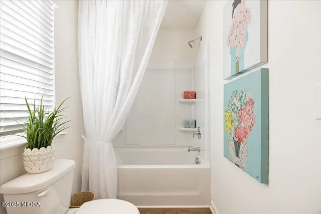 a bathroom with a potted plant and a sink