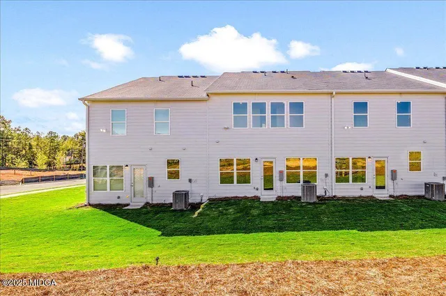 a view of a house with a backyard