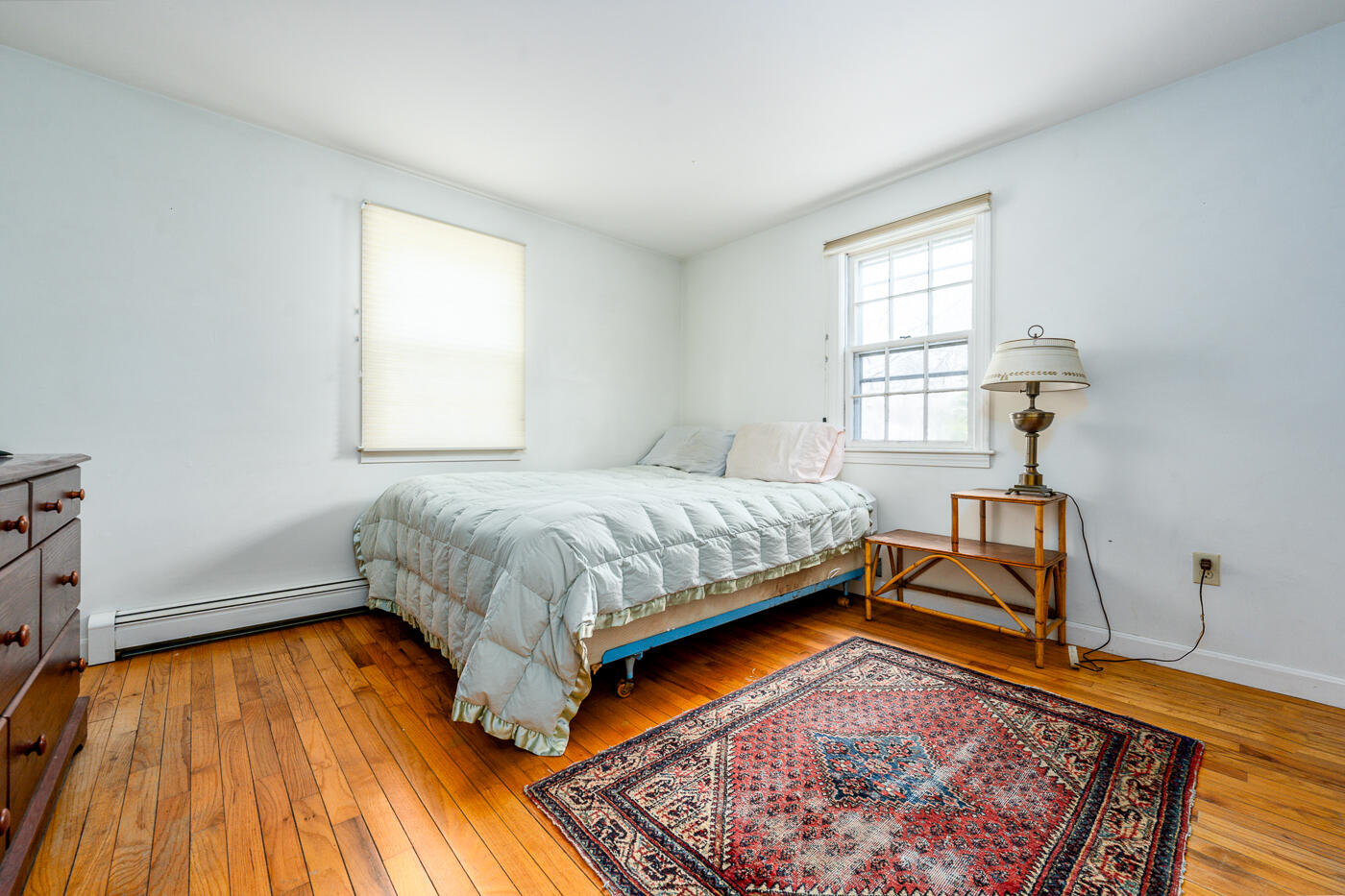 45 Sheffield Road Brewster, MA 02631 - Photo 13 of 25 a bedroom with a bed and wooden floor