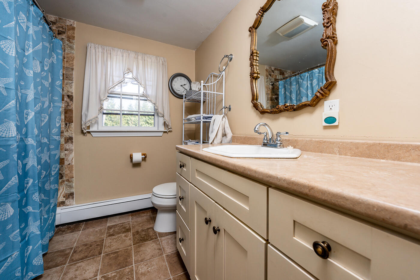 45 Sheffield Road Brewster, MA 02631 - Photo 16 of 25 a bathroom with a granite countertop toilet sink and mirror