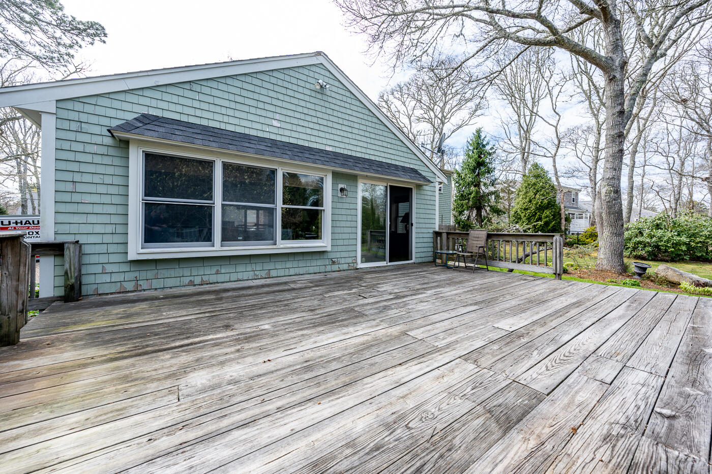 45 Sheffield Road Brewster, MA 02631 - Photo 19 of 25 a view of a house with a large window and wooden fence