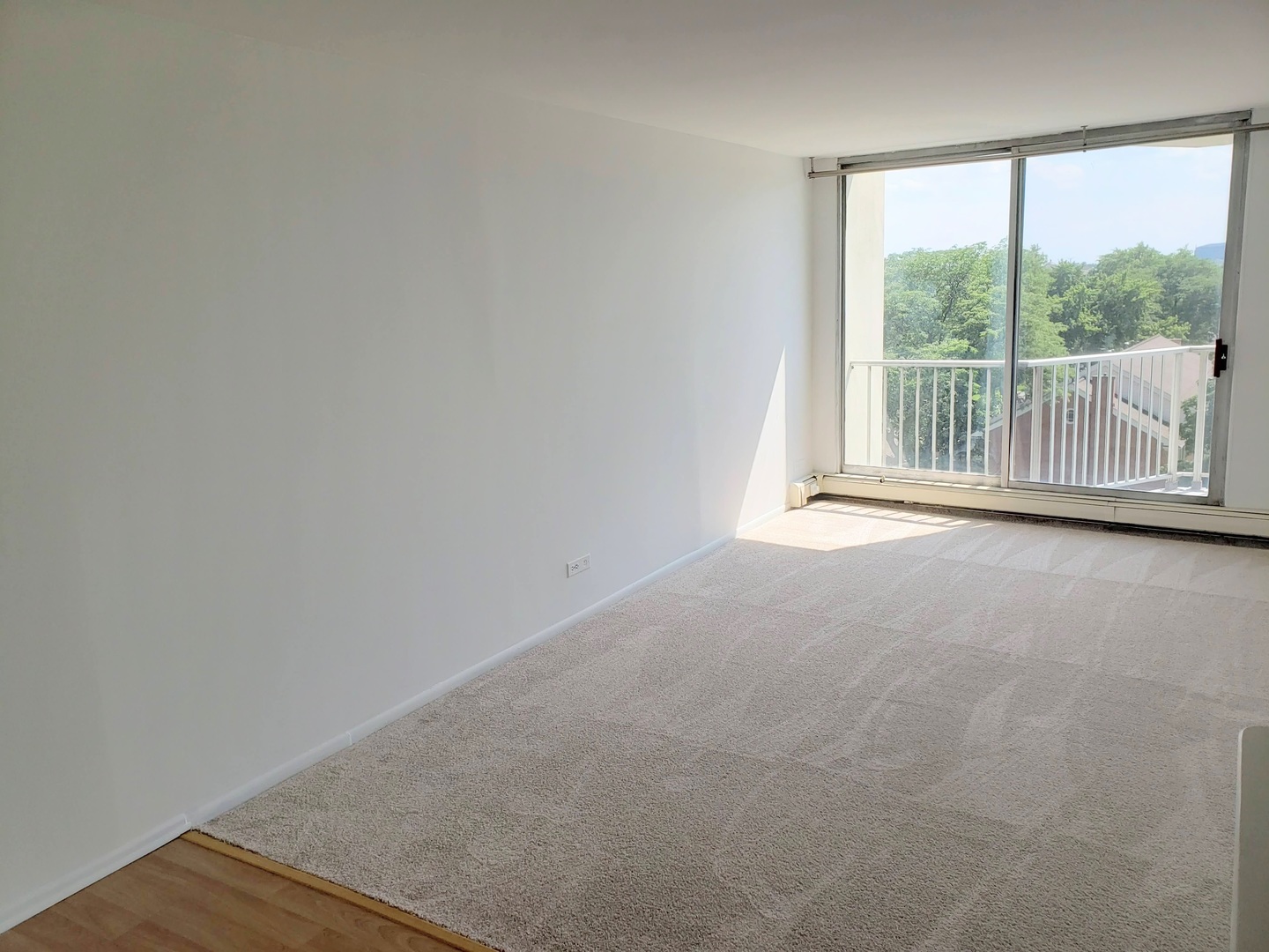 40 North Tower Road, Unit 5B Oak Brook, IL 60523 - Photo 9 of 25 an empty room with wooden floor and windows
