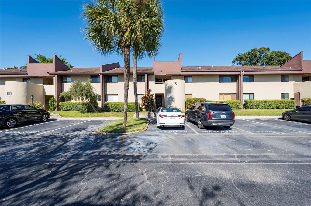 735 South Village Drive, Unit 206 St. Petersburg, FL 33716 - Photo 1 of 45 a view of a car park in front of a house