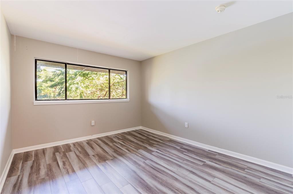 735 South Village Drive, Unit 206 St. Petersburg, FL 33716 - Photo 19 of 45 a view of room with window and hardwood floor