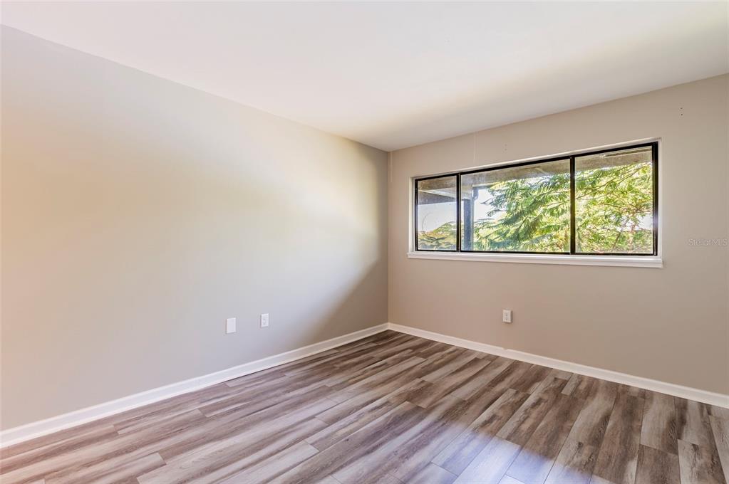735 South Village Drive, Unit 206 St. Petersburg, FL 33716 - Photo 20 of 45 wooden floor in an empty room with a window