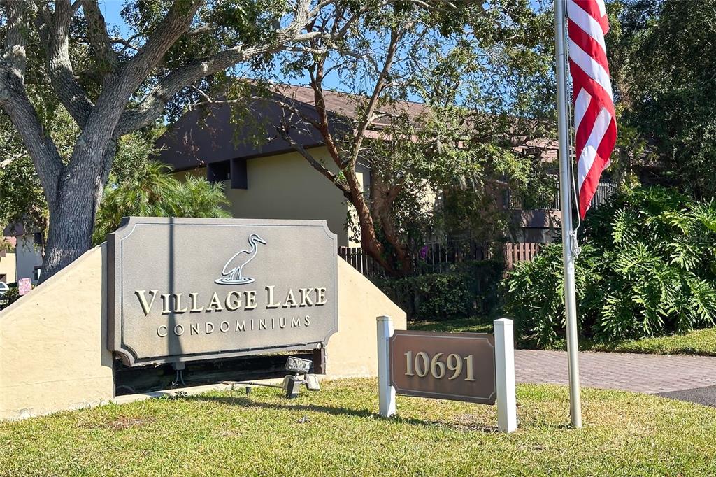 735 South Village Drive, Unit 206 St. Petersburg, FL 33716 - Photo 2 of 45 a sign broad on the side of the road