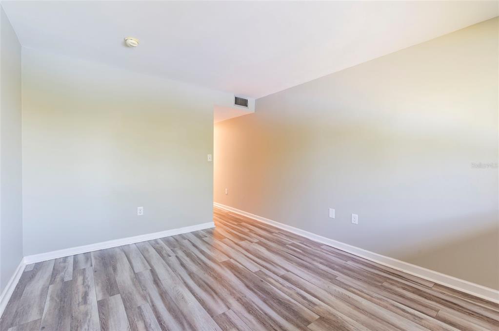 735 South Village Drive, Unit 206 St. Petersburg, FL 33716 - Photo 21 of 45 a view of an empty room with wooden floor