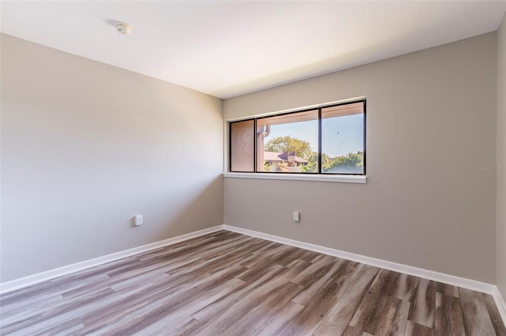 735 South Village Drive, Unit 206 St. Petersburg, FL 33716 - Photo 24 of 45 a view of empty room with wooden floor