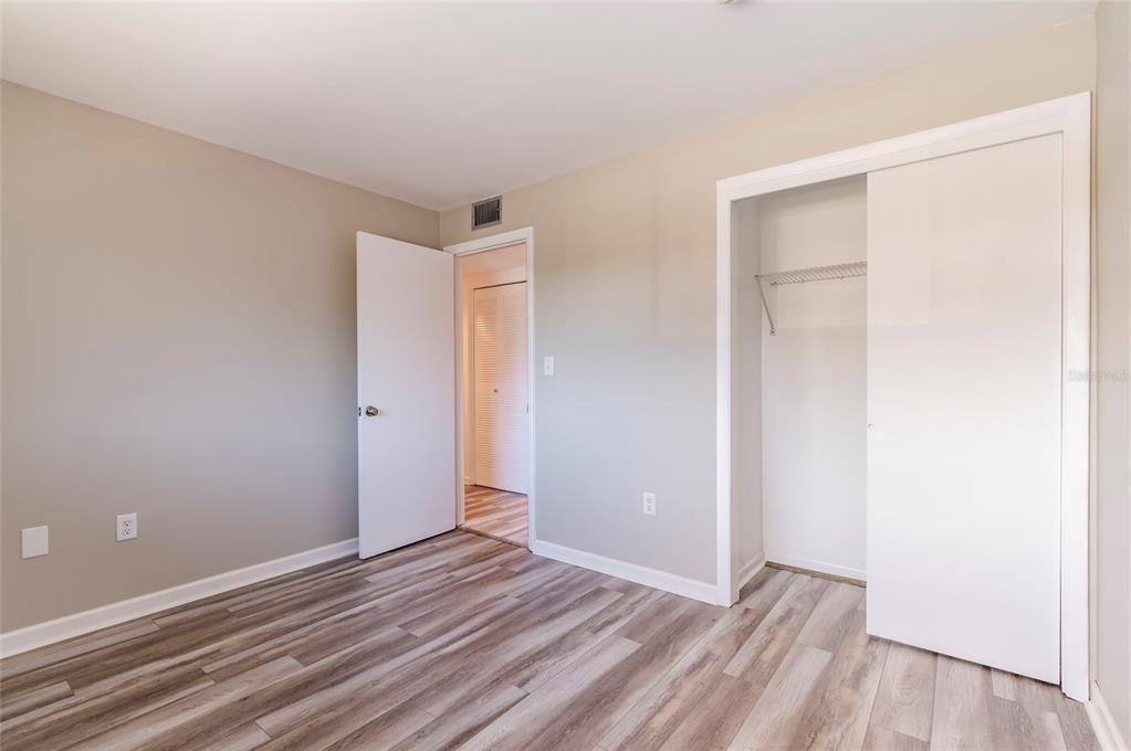 735 South Village Drive, Unit 206 St. Petersburg, FL 33716 - Photo 25 of 45 a view of an empty room with wooden floor