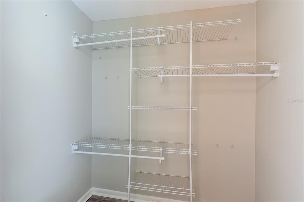 735 South Village Drive, Unit 206 St. Petersburg, FL 33716 - Photo 28 of 45 a room with a closet and wooden floor