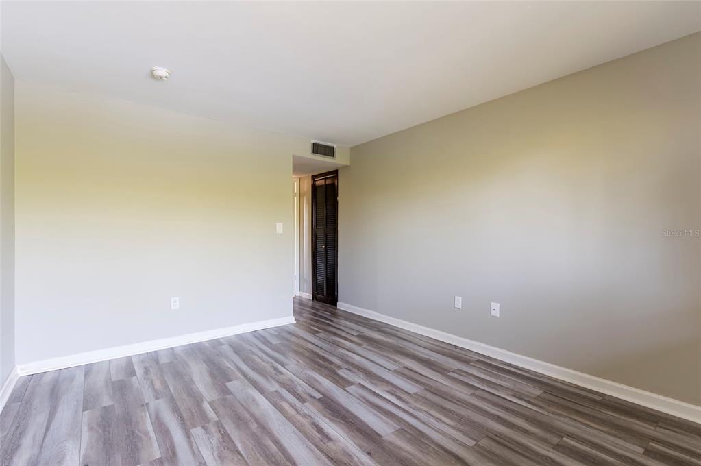 735 South Village Drive, Unit 206 St. Petersburg, FL 33716 - Photo 31 of 45 a view of an empty room with wooden floor