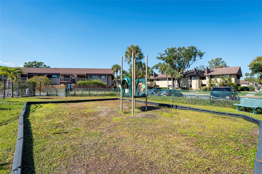 735 South Village Drive, Unit 206 St. Petersburg, FL 33716 - Photo 36 of 45 a swimming pool with outdoor seating and yard
