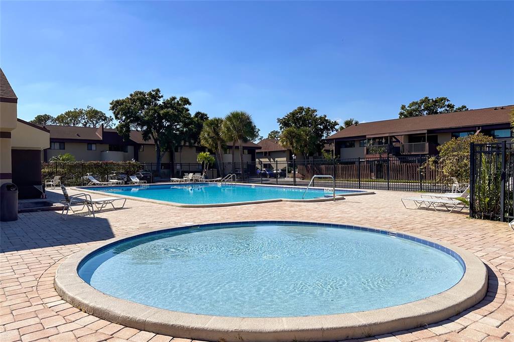 735 South Village Drive, Unit 206 St. Petersburg, FL 33716 - Photo 37 of 45 a view of outdoor space yard swimming pool and outdoor seating