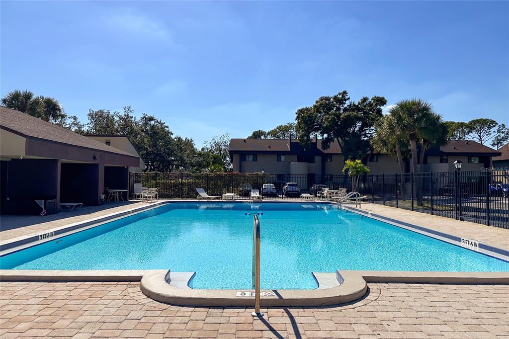 735 South Village Drive, Unit 206 St. Petersburg, FL 33716 - Photo 39 of 45 a view of swimming pool with outdoor seating and plants