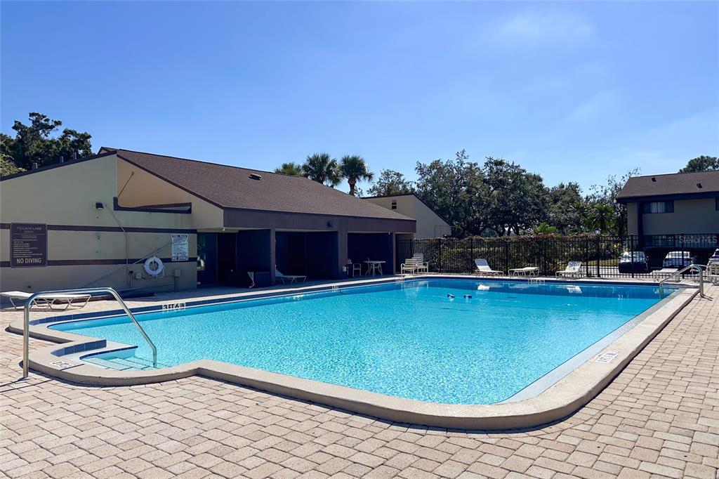 735 South Village Drive, Unit 206 St. Petersburg, FL 33716 - Photo 40 of 45 a view of a swimming pool with a chair