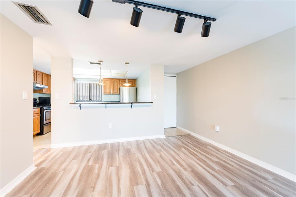 735 South Village Drive, Unit 206 St. Petersburg, FL 33716 - Photo 4 of 45 a view of a kitchen with wooden floor and a sink