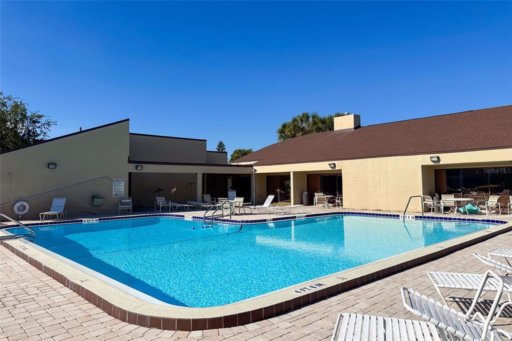 735 South Village Drive, Unit 206 St. Petersburg, FL 33716 - Photo 45 of 45 a view of a house with pool and chairs