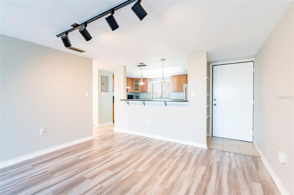 735 South Village Drive, Unit 206 St. Petersburg, FL 33716 - Photo 5 of 45 a view of a kitchen from the hallway