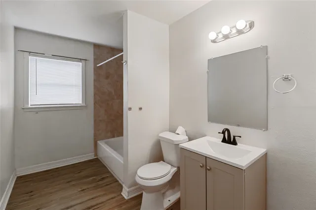 a bathroom with a sink toilet and a mirror