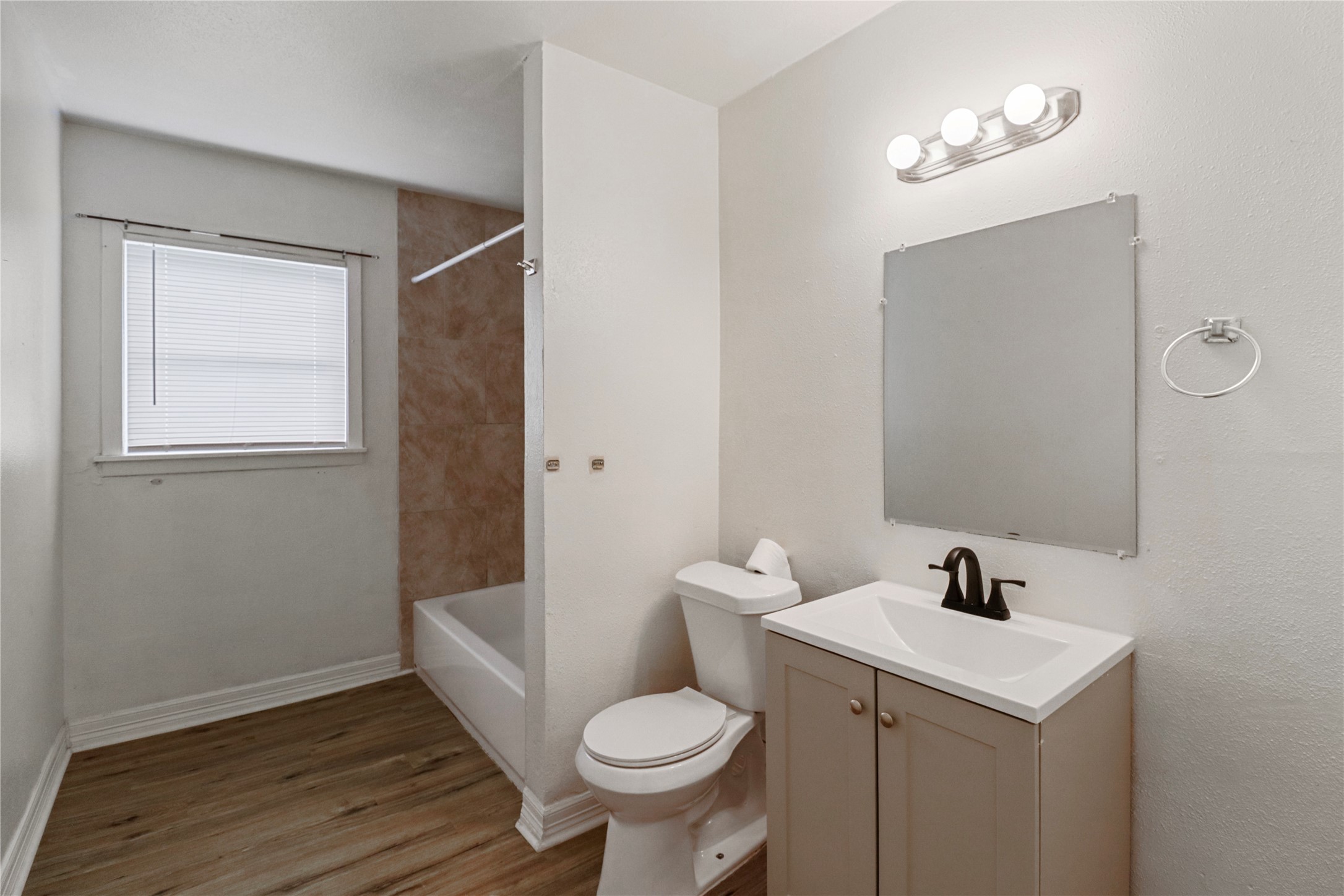 604 West Peach Street Angleton, TX 77515 - Photo 12 of 15 a bathroom with a sink toilet and a mirror