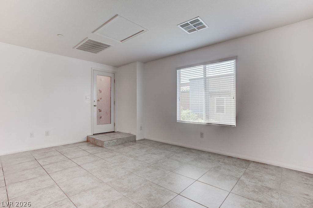 4650 Ranch House Road, Unit 47 North Las Vegas, NV 89031 - Photo 5 of 43 A well-lit, versatile room provides direct exterior access and durable tile flooring throughout.
