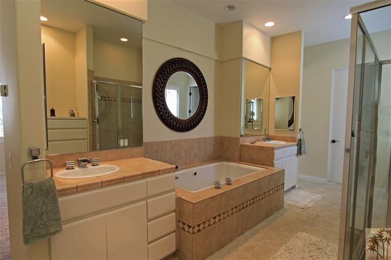 286 Loch Lomond Road Rancho Mirage, CA 92270 - Photo 17 of 24 a bathroom with a tub sink and mirror