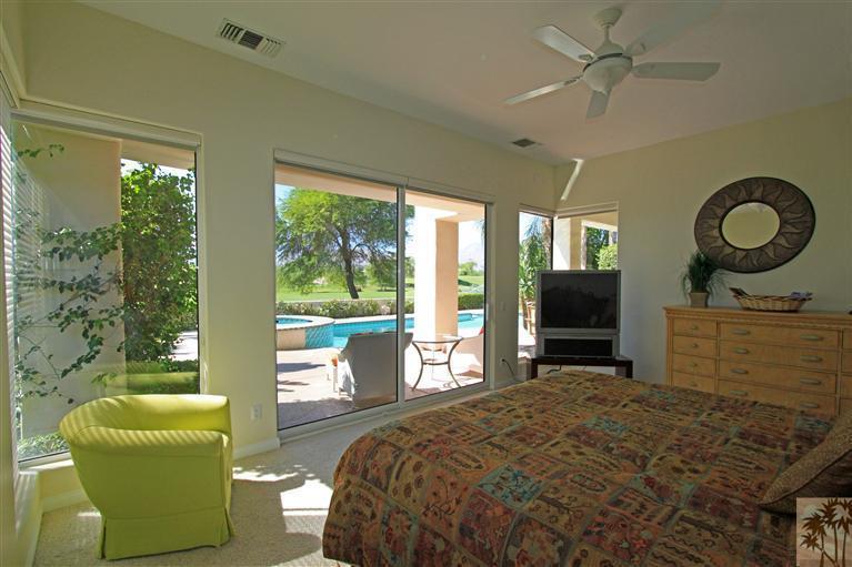 286 Loch Lomond Road Rancho Mirage, CA 92270 - Photo 18 of 24 a bedroom with a bed a window and a flat screen television