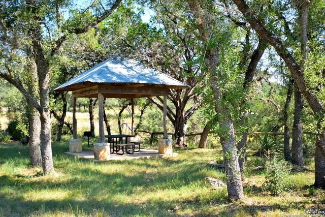 a view of a patio with a table chairs and a backyard