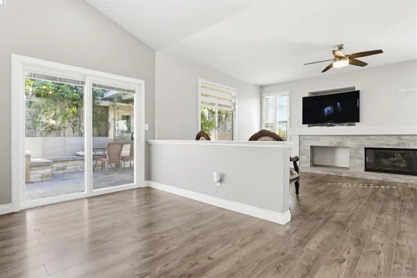 a living room with furniture a flat screen tv and a fireplace