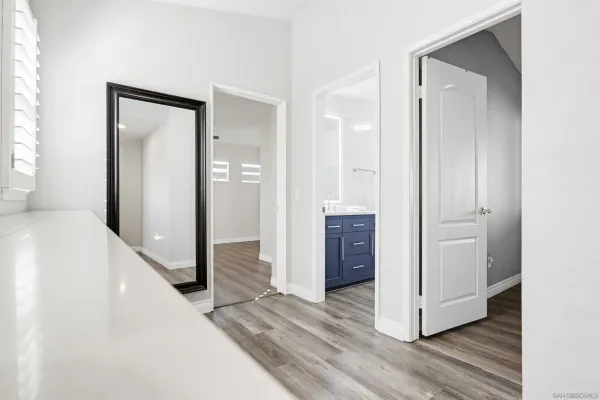 a view of a hallway with closet and wooden floor