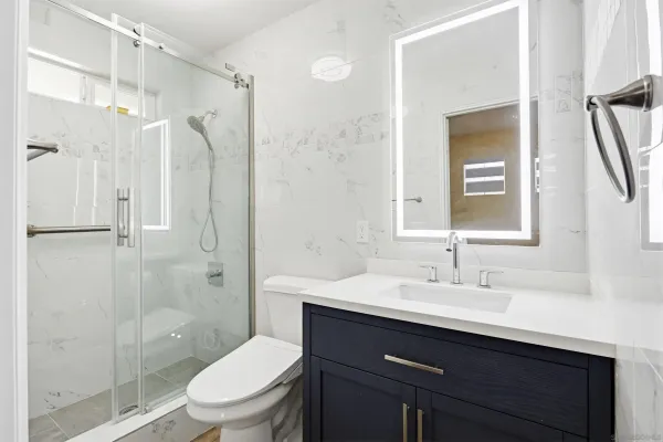 a bathroom with a sink toilet and shower