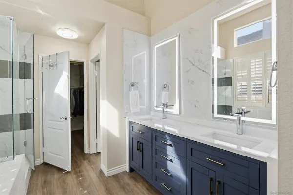 a bathroom with a double vanity sink and mirror