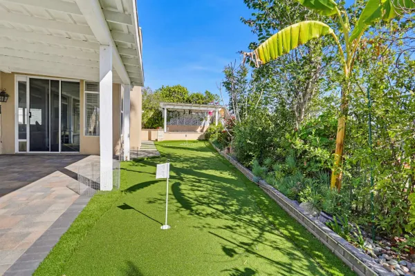a view of a house with a backyard and sitting area