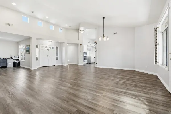 a view of a room with wooden floor and windows