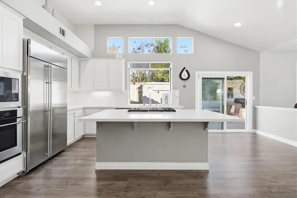 a kitchen with a sink appliances and cabinets