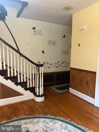 a room with water heater and wooden cabinets