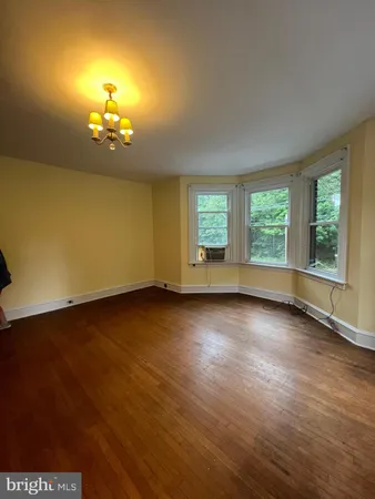 a kitchen with white cabinets a sink a stove and a window