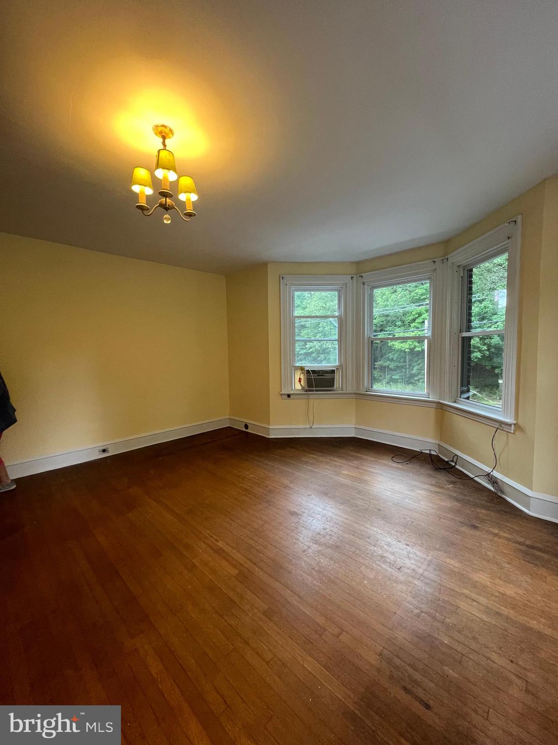 25 Broad Street Ashland, PA 17921 - Photo 41 of 138 an empty room with wooden floor chandelier and windows
