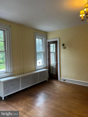 a view of a room with a ceiling fan