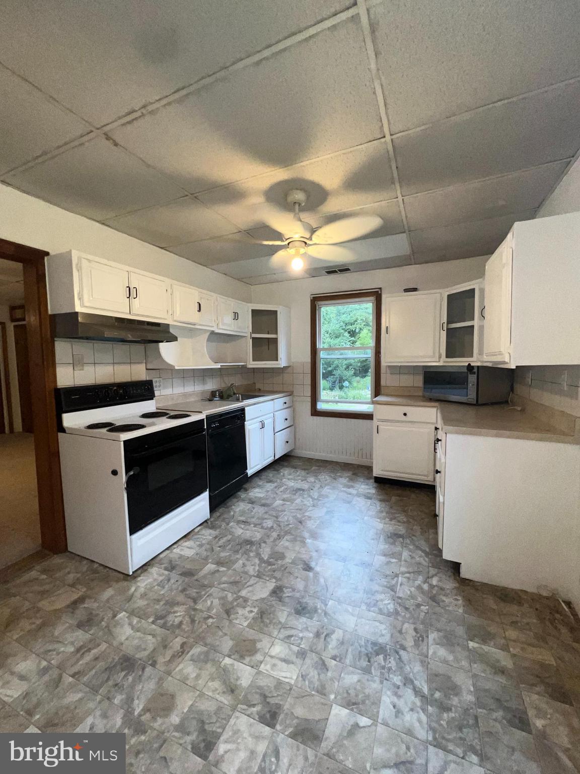 25 Broad Street Ashland, PA 17921 - Photo 100 of 138 a kitchen with stainless steel appliances granite countertop a stove sink and cabinets