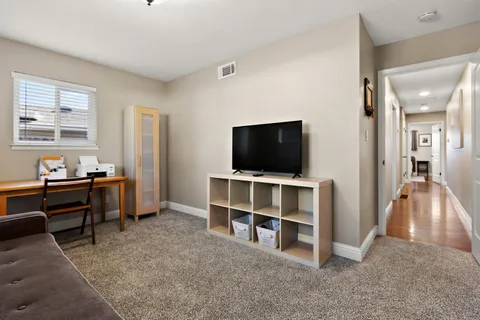 a view of a livingroom with furniture and a flat screen tv