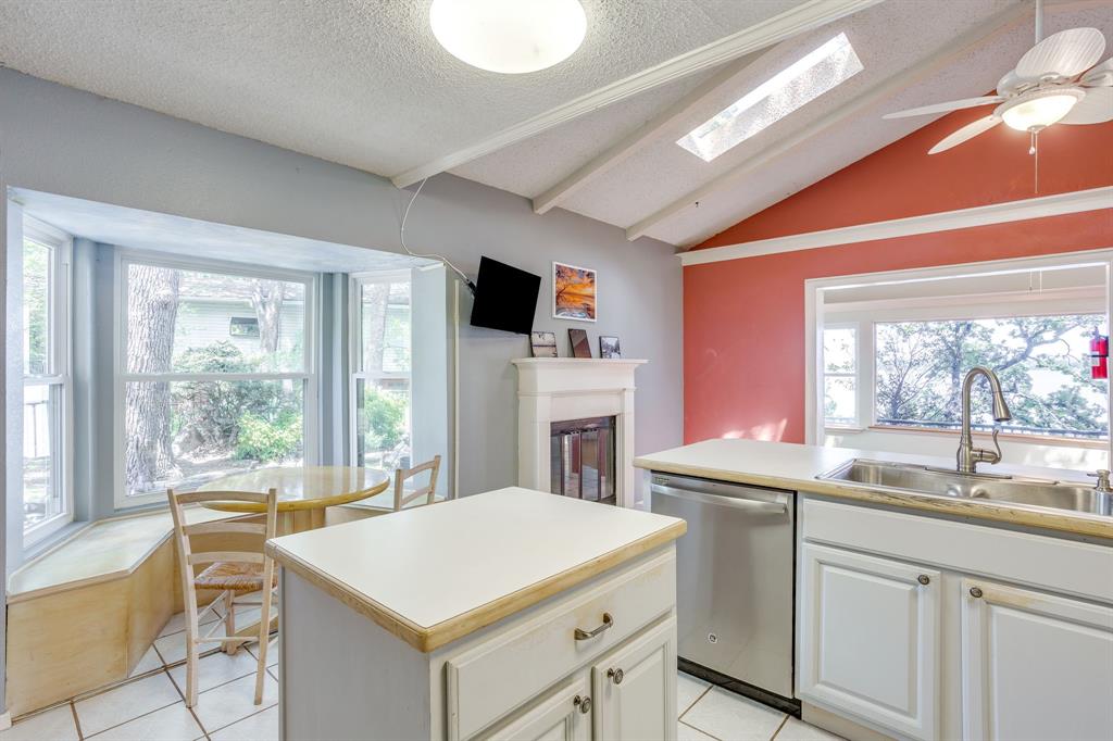 13350 Miller Road Azle, TX 76020 - Photo 18 of 40 a kitchen that has a sink a table and chairs in it