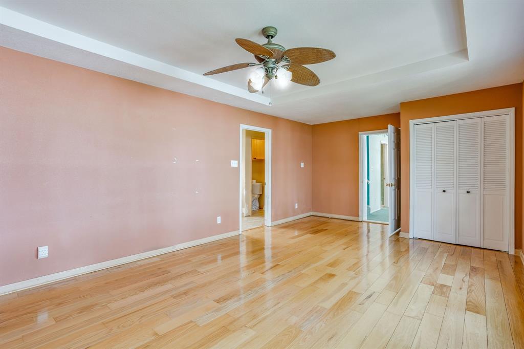13350 Miller Road Azle, TX 76020 - Photo 25 of 40 a view of an empty room with wooden floor and a ceiling fan
